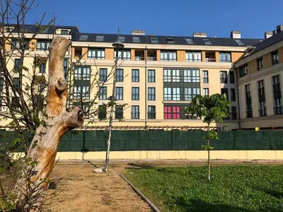 a large building in the background with a tree at Apartamento para 6 personas con piscina y paddle in Foz