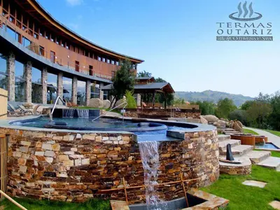 a large stone fountain in front of a building at Casa Regente in O Viso