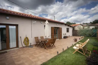 a patio with a table and chairs next to a house at Casa Regente in O Viso