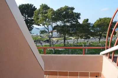 a balcony with a view of a park at Precioso ático a pie de playa, en Miño. in Miño