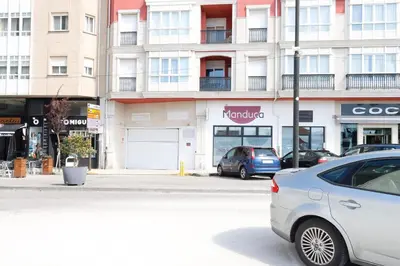 a white car parked in front of a building at ESTRELLA de RIBADEO in Ribadeo