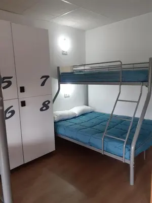 a room with two bunk beds and a blue mattress at ALBERGUE LEMAVO in Monforte de Lemos