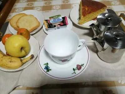 a table with plates of food and a cup of coffee at ALBERGUE LEMAVO in Monforte de Lemos