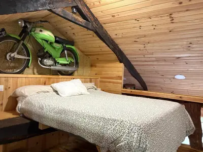a bedroom with a bed and a stone wall at O Viraventos in Betanzos