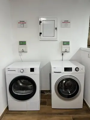 a laundry room with a washer and dryer at HOSTEL PORTON in Lugo