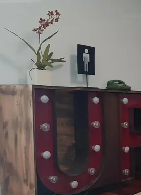 a wooden dresser with a mirror and a sign on it at MAXIMO CONFORT in Lugo
