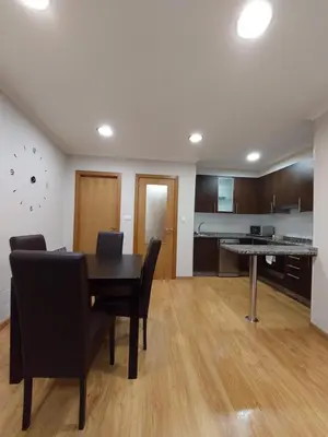a dining room with a table and chairs and a kitchen at Casa Tarrazo in Monforte de Lemos