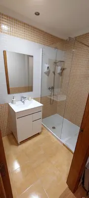 a bathroom with a shower and a sink and a mirror at Casa Tarrazo in Monforte de Lemos