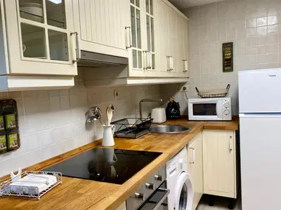 a kitchen with a sink and a stove top oven at Apartamentos Rurales Ca Lulón in Navelgas
