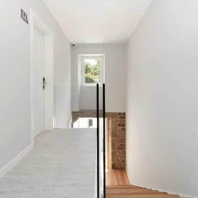 a hallway of a house with white walls and a window at Ultreia Seven Rooms by Adeloló in Santiago de Compostela