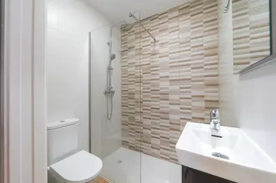 a bathroom with a toilet and a sink and a shower at Ultreia Seven Rooms by Adeloló in Santiago de Compostela