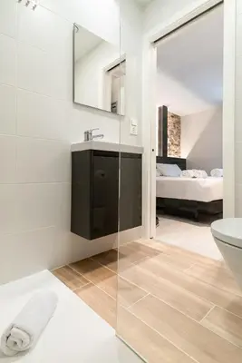 a bathroom with a glass shower and a sink at Ultreia Seven Rooms by Adeloló in Santiago de Compostela