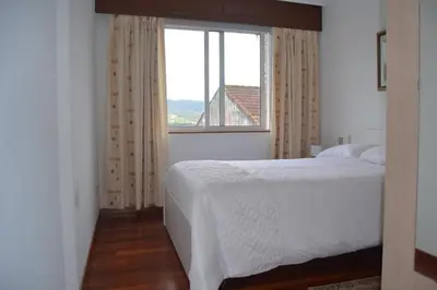 a bedroom with a bed and a large window at Precioso apartamento de 3 habitaciones en Cabañas. in Cabañas