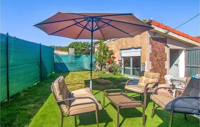 a group of chairs and an umbrella on a yard at Stunning Home In A Peroxa With Wifi in La Peroja