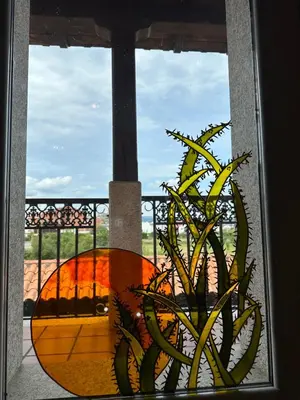 a window with a view of a plant at O toxal in Monforte de Lemos