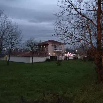 a house in a yard at night with lights at O toxal in Monforte de Lemos