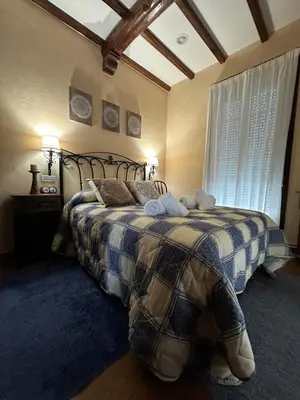 a bedroom with a bed with two stuffed animals on it at O toxal in Monforte de Lemos