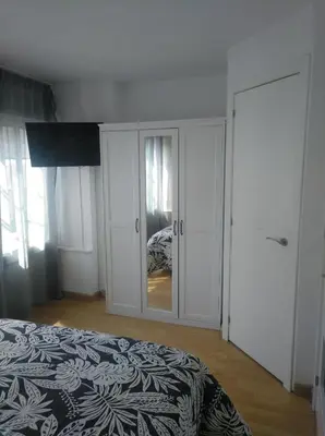 a bedroom with a bed and a cabinet with a mirror at Estudio. Sada, A Coruña. in Sada
