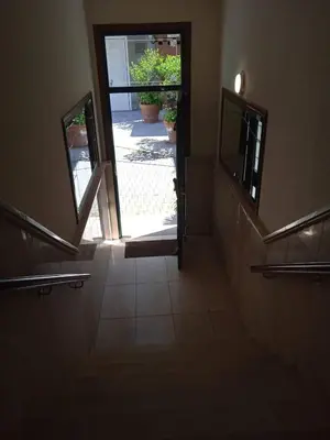 a hallway with a stairway with a door and a window at Estudio. Sada, A Coruña. in Sada