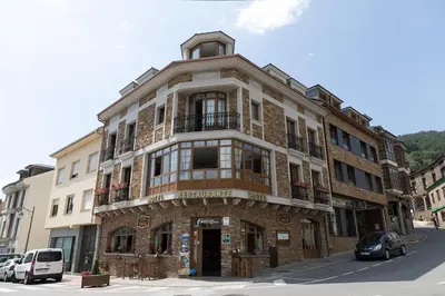 a large brick building on the corner of a street at Apartamentos Casa Paulino in Taramundi