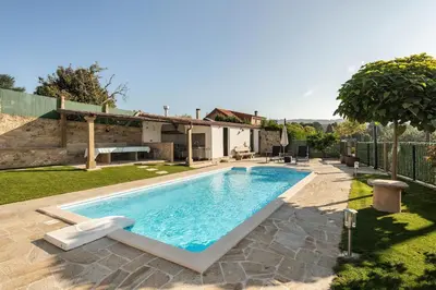 a swimming pool in the backyard of a house at A Casa Romeu in Santiago de Compostela