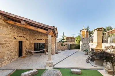a patio with a hammock in the middle of a building at A Casa Romeu in Santiago de Compostela
