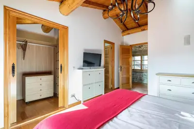 a bedroom with a large bed and a tv at A Casa Romeu in Santiago de Compostela