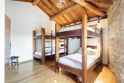 a bedroom with three bunk beds in a room at A Casa Romeu in Santiago de Compostela