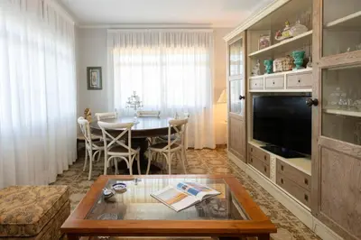 a living room with a table and a dining room at Casa Jesús in A Capela