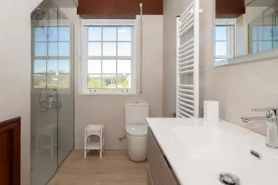 a bathroom with a toilet and a glass shower at Casa Jesús in A Capela