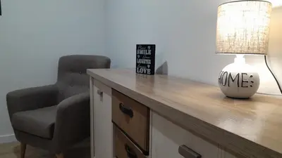 a desk with a chair and a lamp and a lamp at Apartamento a Carballeira in Lugo