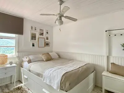 a white bedroom with a bed and a ceiling fan at RIBEIRA SACRA La Imperfecta in Ferreira de Panton