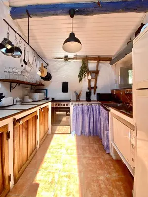 a large kitchen with wooden cabinets and a counter top at RIBEIRA SACRA La Imperfecta in Ferreira de Panton