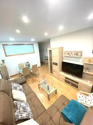 a living room with a couch and a flat screen tv at APTO CÉNTRICO ARENAL FAMILY, PARKING GRATIS in Lugo