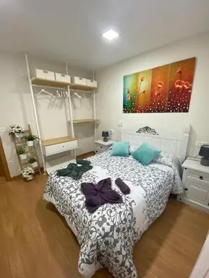 a bedroom with a bed with bows on it at APTO CÉNTRICO ARENAL FAMILY, PARKING GRATIS in Lugo