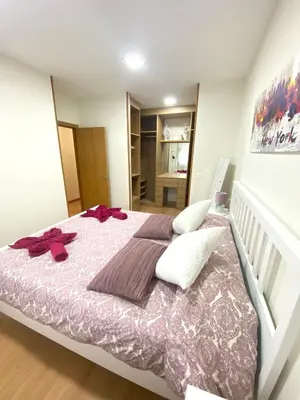 a bedroom with a large bed with bows on it at APTO CÉNTRICO ARENAL FAMILY, PARKING GRATIS in Lugo