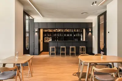 a restaurant with wooden tables and chairs and a bar at Exe Peregrino in Santiago de Compostela