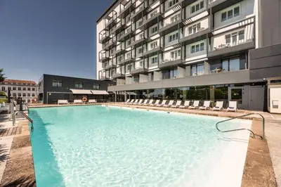 a large swimming pool in front of a building at Exe Peregrino in Santiago de Compostela