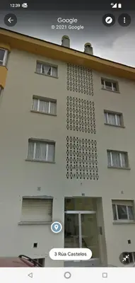 a white building with a sign on the side of it at Viveiro-Lugomar in Viveiro