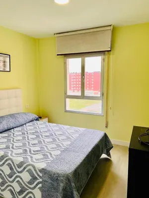 a bedroom with a bed and a window at Viveiro-Lugomar in Viveiro