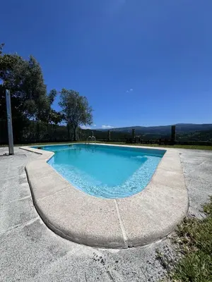 a swimming pool in the middle of a road at Casa 2 habitaciones con piscina y cenador al aire libre in Pontevedra