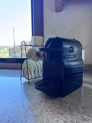 a toaster oven sitting on the floor in a room at Casa 2 habitaciones con piscina y cenador al aire libre in Pontevedra