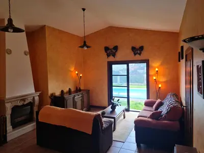 a living room with two couches and a fireplace at Casa 2 habitaciones con piscina y cenador al aire libre in Pontevedra