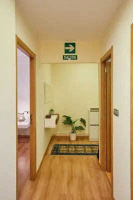 a hallway with an exit sign in a room at Vut Salvador Santiago in Santiago de Compostela