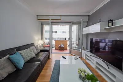 a living room with a couch and a tv at Vut Salvador Santiago in Santiago de Compostela