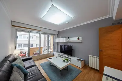 a living room with a couch and a table at Vut Salvador Santiago in Santiago de Compostela