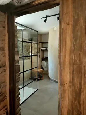 a room with a glass door leading to a kitchen at Granja Labrada: Alojamiento con caballos in Santa María