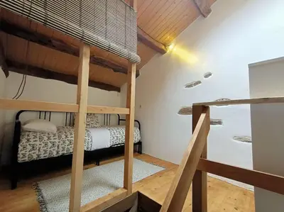 a bedroom with a bunk bed in a room at Granja Labrada: Alojamiento con caballos in Santa María