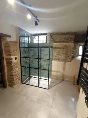 a room with a large glass door in a building at Granja Labrada: Alojamiento con caballos in Santa María