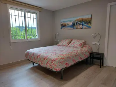 a bedroom with a bed and two windows at Apartamento Vistas Pedrido in Paderne
